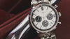 Timex Marlin Chronograph Tachymeter with silver dial and black subdials rotating on display, highlighting stainless-steel bracelet, polished case, and chronograph detailing.