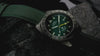 Video showcasing Timex Expedition Pioneer Titanium Automatic GMT watch, highlighting green dial, lume, titanium case, and outdoor durability.