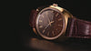 TW2Y87200 Close-up views of the Timex 1978 Day Date Fumé Reissue highlighting its gold-tone case, brown gradient dial, day-date window, and brown leather strap.
