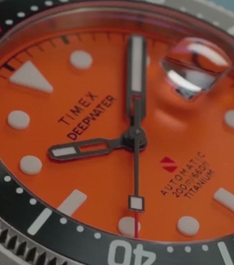 Angled view of the Timex Deepwater Reef 200 Titanium Automatic dive watch showcasing blue dial and rotating bezel