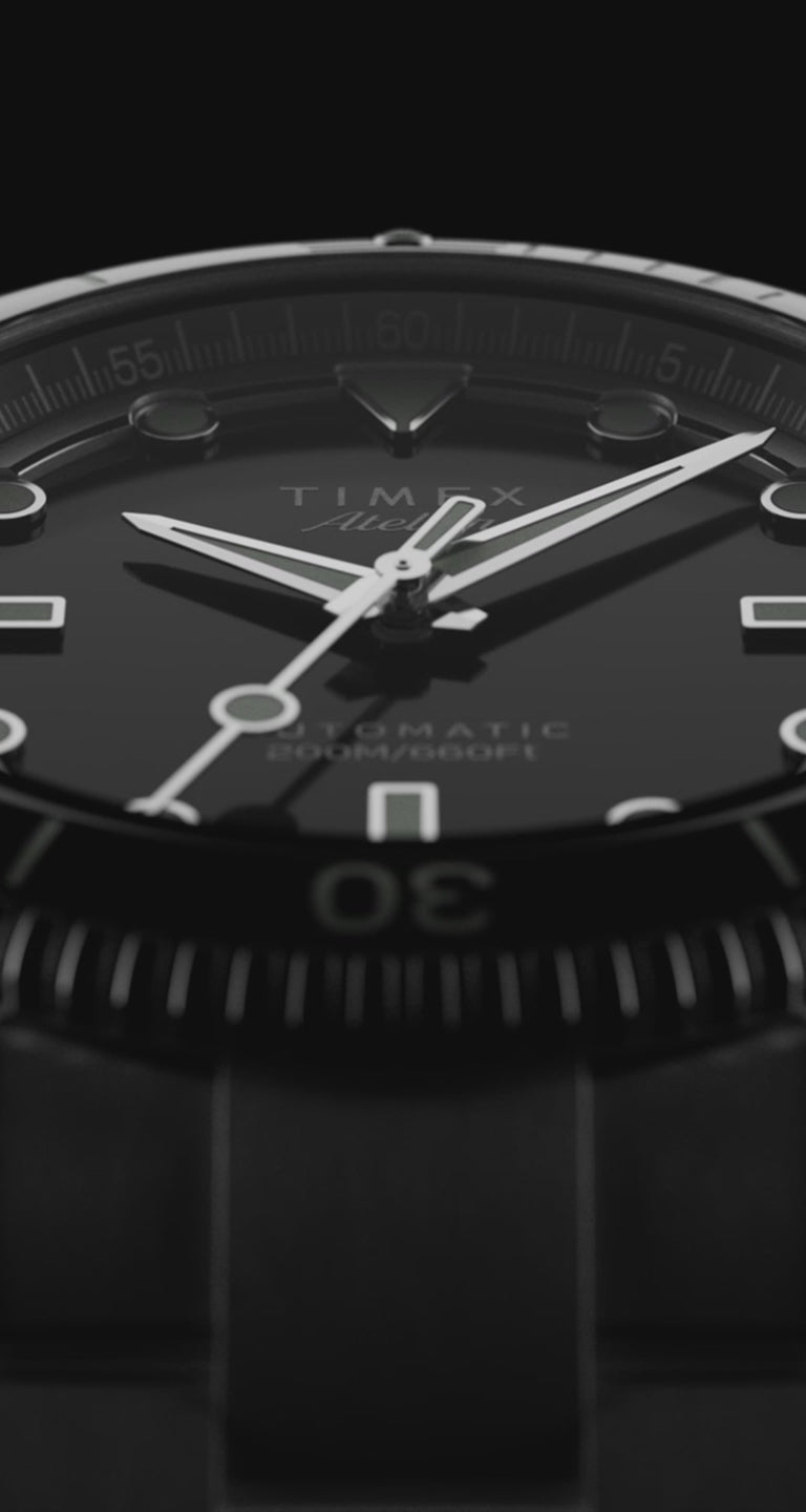 A cinematic showcase of the Timex Atelier automatic dive watch. The video highlights extreme close-ups of the polished stainless steel case, rotating bezel, engraved crown, and luminous black dial. It transitions between macro shots of the movement, exploded technical components, and lifestyle angles, emphasizing Swiss-made craftsmanship, 200M water resistance, and premium finishing.